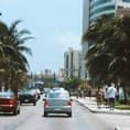 Photograph of a vehicle carrying passengers on the streets of Cancun